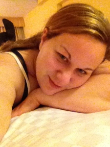 Me on my big king bed with so many pillows.